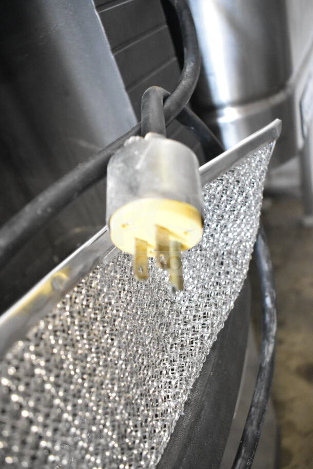 Manitowoc ice machine power plug on metallic surface; sturdy commercial-grade construction.