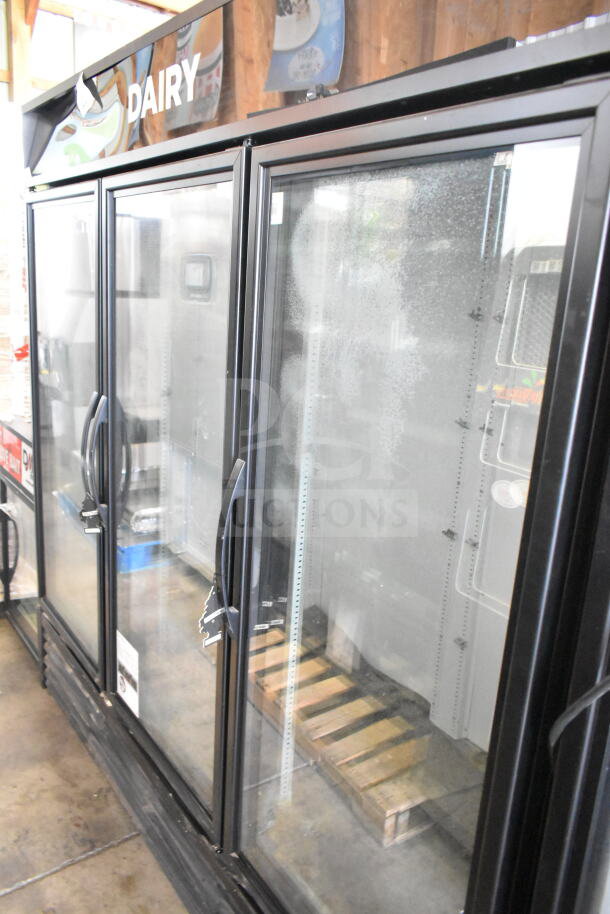 2019 True GDM-72-HC Commercial 3 Door Cooler. Black frame, glass doors, "DAIRY" sign, commercial use, 115V, 1 phase.