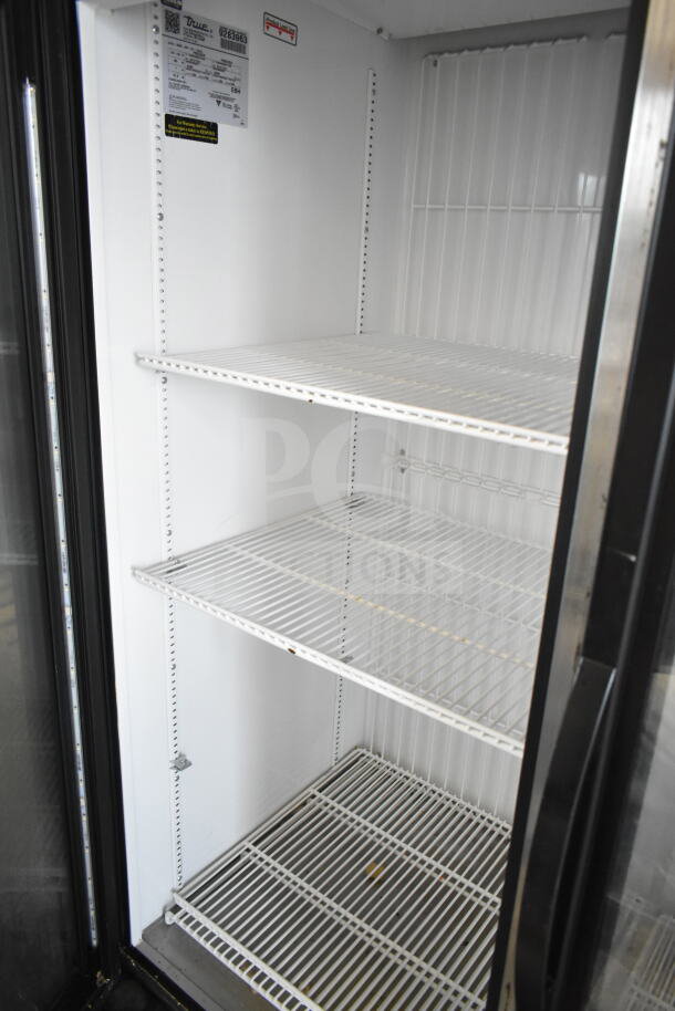 2018 True GDM-49F-HC commercial 2-door reach-in freezer with wire shelving, label indicating 115/208-230V, 1 phase.