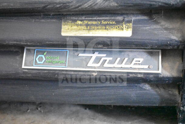 2018 True GDM-49F-HC freezer label showing "natural refrigerant." Warranty service sticker above.