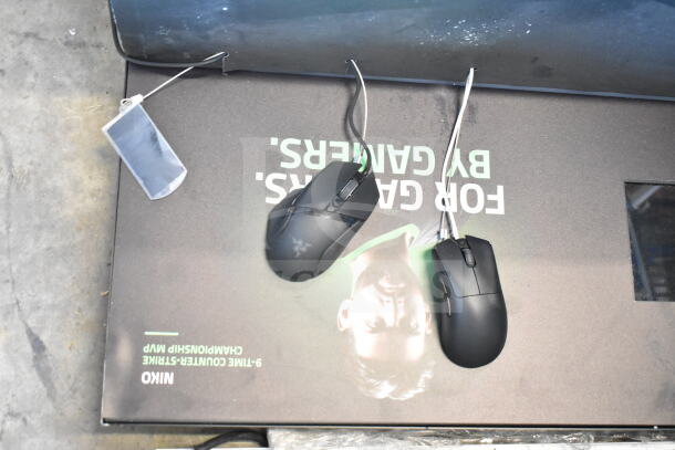 Three store display panels featuring computer mice, visible branding, and promotional text. Items are in used condition.