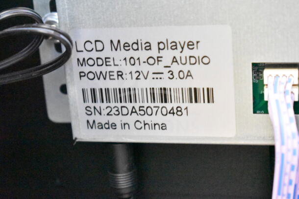 LCD Media Player label, Model: 101-OF_AUDIO, Power: 12V 3.0A, SN: 23DA5070481, Made in China.