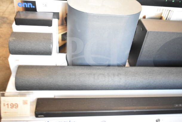 Store display featuring various onn. sound bars and speakers, in good condition. Price tag shows $199.