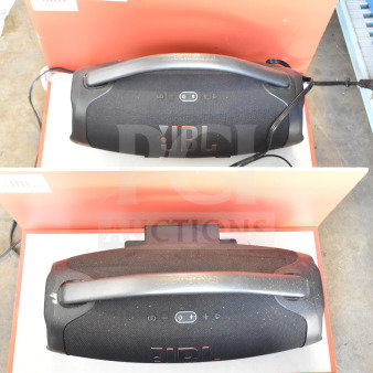 Two JBL Boombox 3 speakers in store display; features include massive sound, waterproof design, and 24-hour playtime.