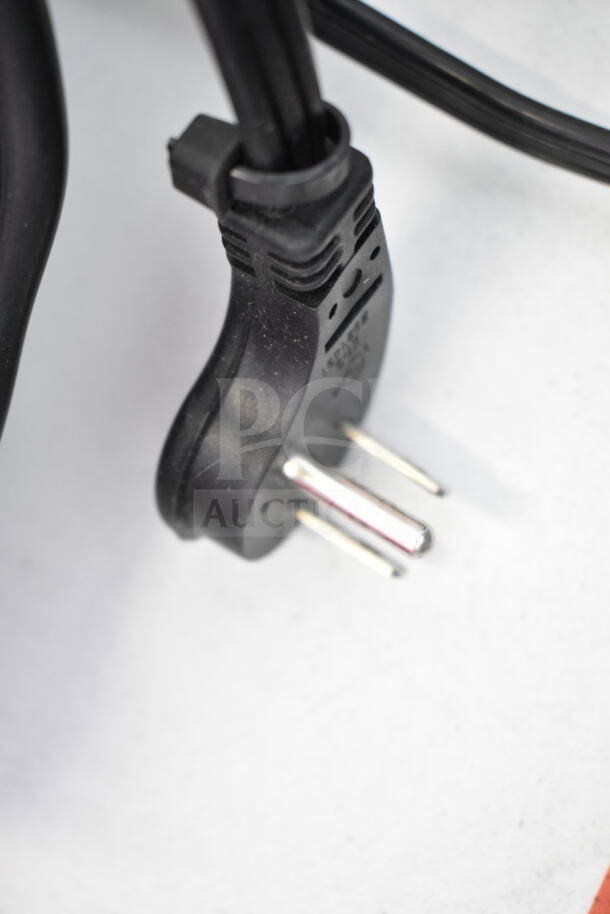 Close-up of a black, two-pronged plug from a store display item, possibly related to JBL Boombox 3 Speaker.