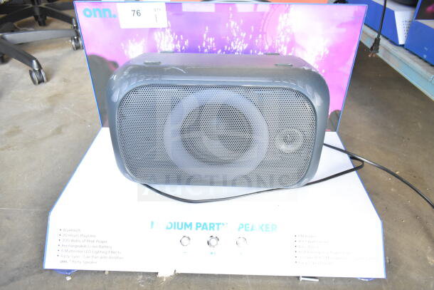Onn Medium Party Speaker store display showing Bluetooth, 200W power, 20-hour battery, LED lighting, in good condition.