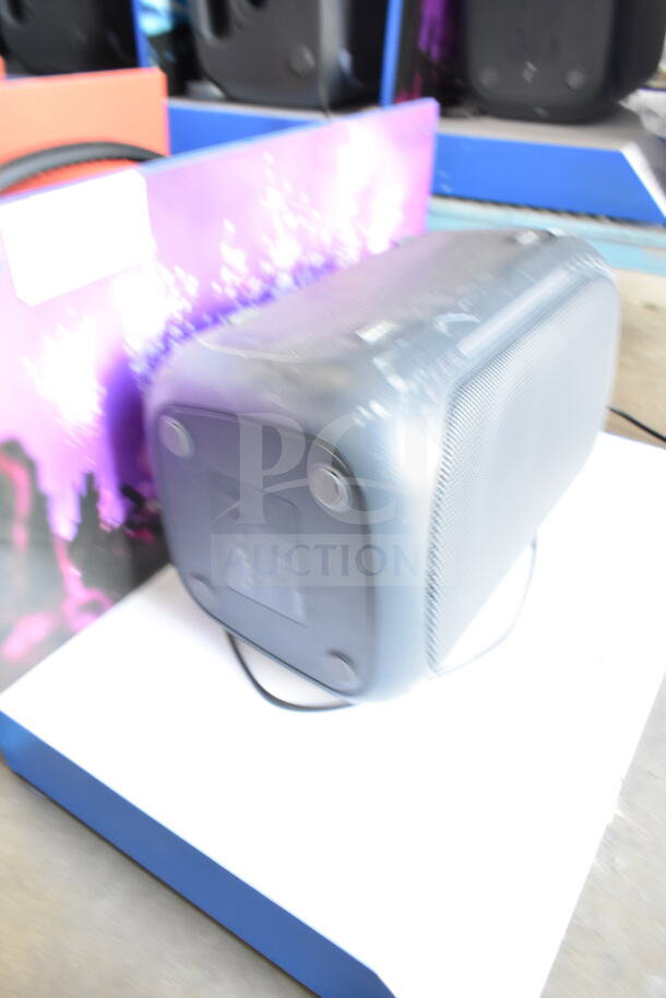 Onn Medium Party Speaker display unit in retail setting, visible gray casing and control panel, moderate condition.
