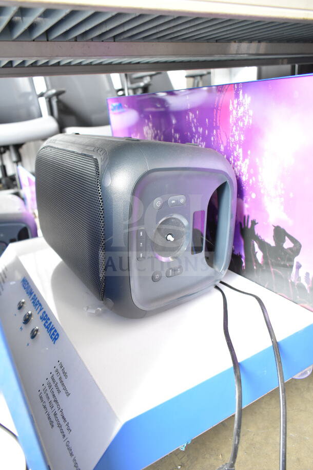 Medium party speaker on store display, featuring FM radio, waterproof design, 6.5" subwoofer, USB, AUX, and microphone inputs.