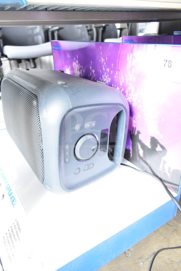 Onn medium party speaker on display. Features control panel, wireless connectivity, USB input, and dynamic sound.