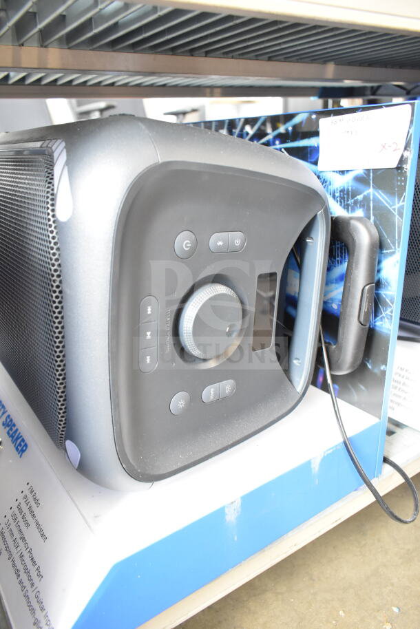 Large party speaker in display setup, featuring control panel with volume knob, buttons for playback, and power. Good condition.