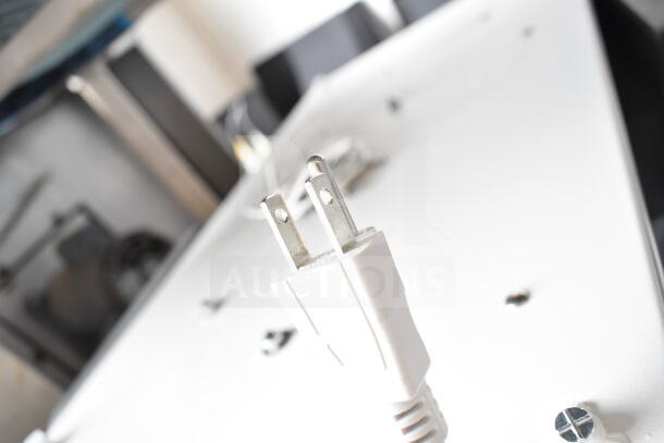 3 Store display with Ion speaker, showcasing a power plug. Appears in good condition. Great for retail settings.