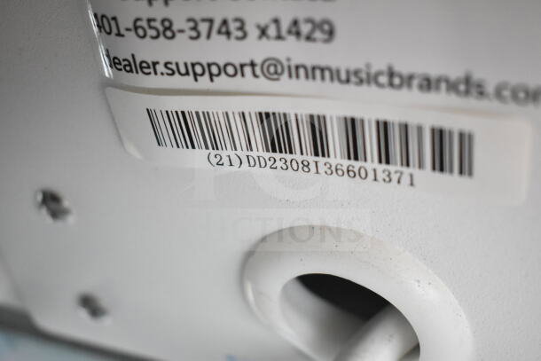 Barcode close-up on a 3-store display with Ion speaker, showing support contact and serial number DD2308136601371.