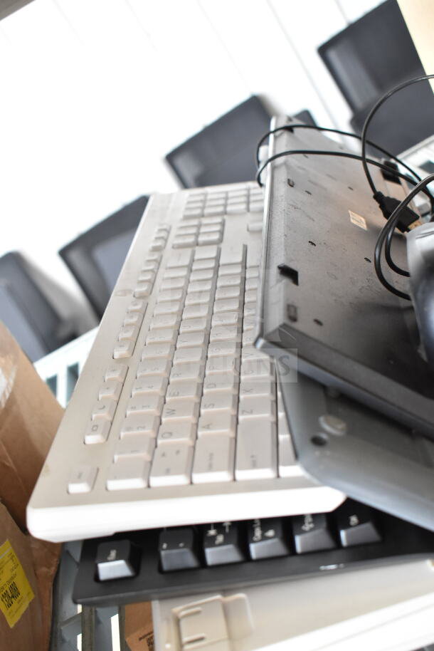 15 various items including Sensomatic AMB-9010-IPS, Sensormatic ZBSMPCPEF, assorted keyboards. Mixed condition.