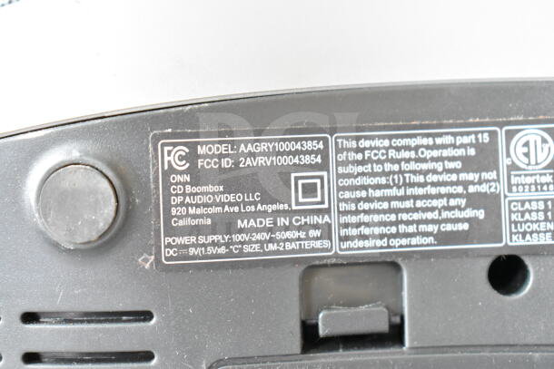Alt text: ONN CD Boombox label shows model AAGRY100043854, FCC ID 2AVRV100043854, with power supply details.