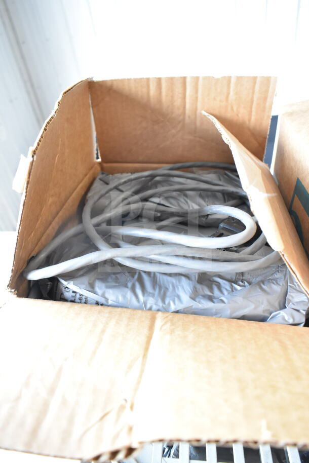 Cardboard box with coiled cables inside for Sensormatic antennas, showing partial content. Condition appears new.