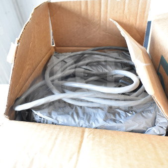 Cardboard box with coiled cables inside for Sensormatic antennas, showing partial content. Condition appears new.