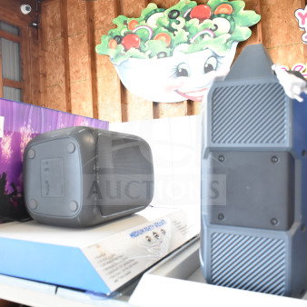 2-store display with Medium Party Speaker and Ion Speaker; on shelves with packaging visible; good condition.