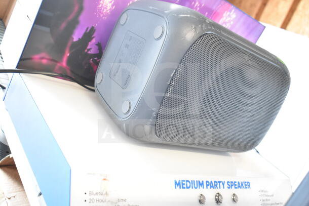 Medium party speaker with labeled box, showing features like Bluetooth and 20-hour playtime, slight surface wear.