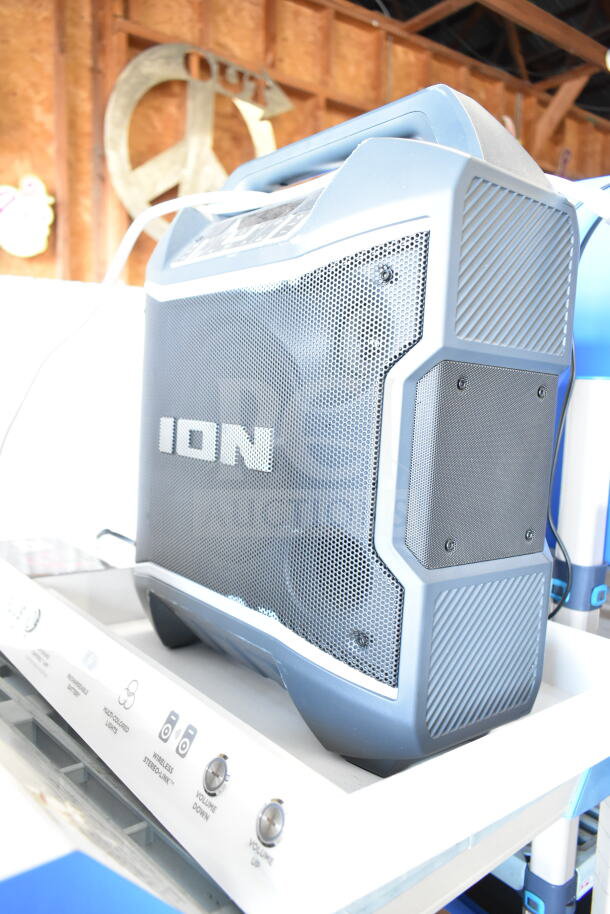 Ion speaker on display stand featuring volume controls, wireless stereo link, and audio-focused design. Appears in new condition.