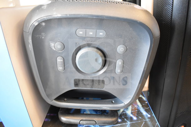 Onn Large Party Speaker display, featuring control panel with volume and function buttons. Slightly scratched surface, good condition.