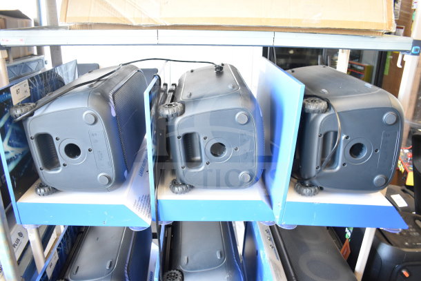 3 Onn large party speakers in store display, showcasing durable design with wheels and handle; new condition.