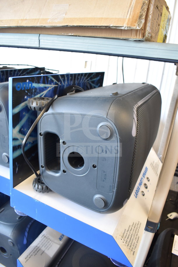 Onn large party speaker in store display; features Bluetooth connectivity, dual drivers, and wheeled transport for portability.
