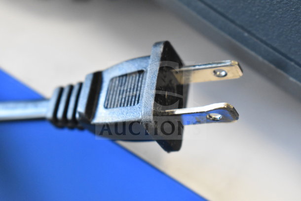 Power plug close-up for Onn Large Party Speaker store display, part of auction lot; power cable intact and clean.