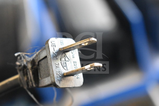 Close-up of a plug for an Onn large party speaker, showing "UE-221 7A 125V" marking. Auction includes 3-store display.
