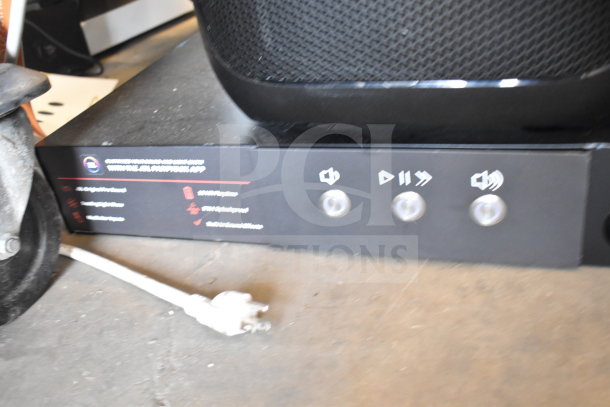 Store display featuring a JBL PartyBox310 speaker with control panel visible. Condition appears lightly used. Tags indicate branding.
