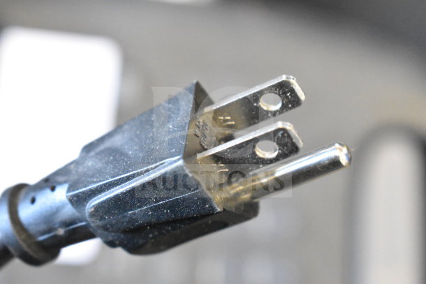 Close-up view of an electrical plug which is part of the JBL PartyBox310 speaker display.