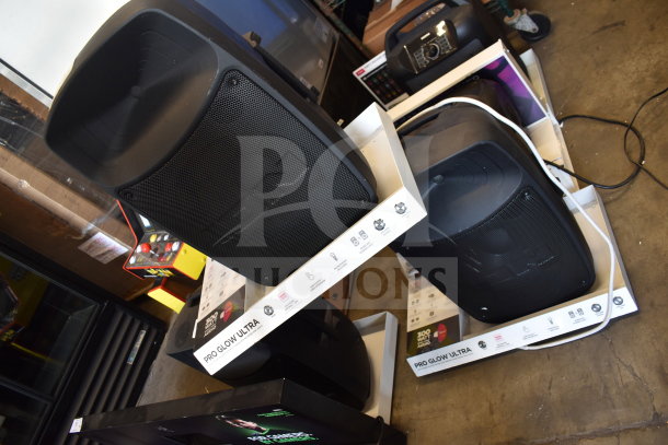 3 Ion Pro Glow Ultra Speakers on display stands, excellent condition, prominent labels indicate model and features.