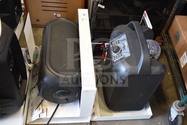 Rave+ and Ion speakers on store display stand; both in good condition, featuring control dials, pre-owned.