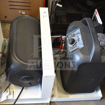 Rave+ and Ion speakers on store display stand; both in good condition, featuring control dials, pre-owned.