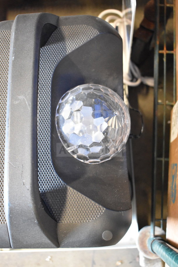 Rave+ speaker display with faceted light dome on top, textured black surface, good condition.