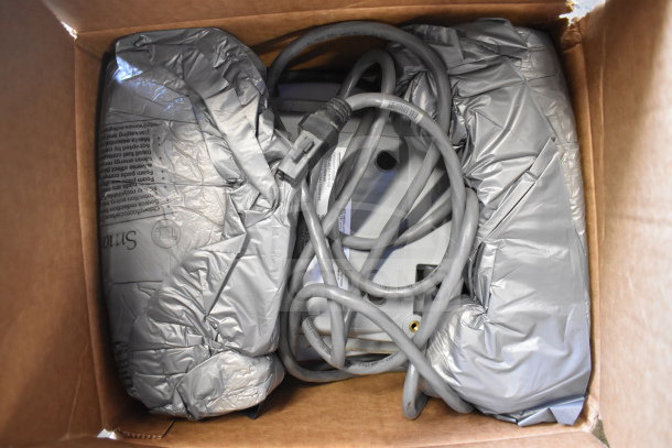 Eight Sensormatic items including ZBSMPCPEF, AMB-9010-IPS, DEAC STP-SD, in box with cables, wrapped in packaging material.