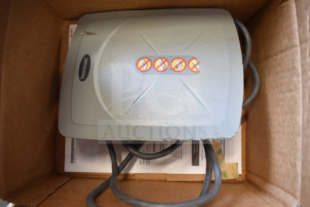 Sensormatic ZBSMPCPEF device in box, grey with visible branding and cables, part of an 8-item lot for auction.