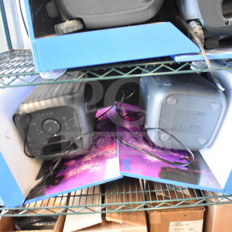 Two Onn Medium Party Speakers in original packaging on a metal shelf. Features include control dials and connectivity ports.