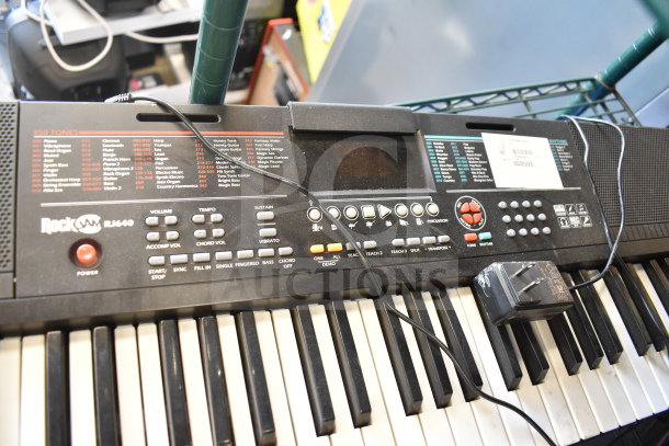 Rockjam RJ640 keyboard with visual interface, various controls, and 350 tones. Includes power adapter. Good condition.
