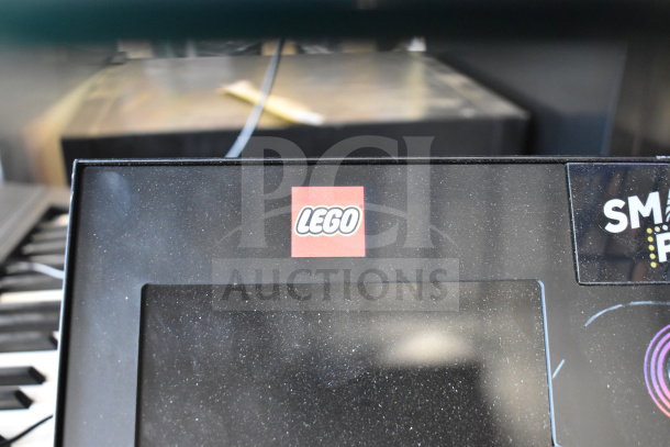 "Lot of 4 items: electronic keyboard, Lego Smart Play station, and walkie talkies, gently used. Lego logo visible."