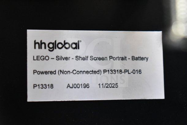 Label on a device reading: "hh global, LEGO – Silver - Shelf Screen Portrait - Battery Powered (Non-Connected) P13318-PL-016, P13318, AJ00196, 11/2025."