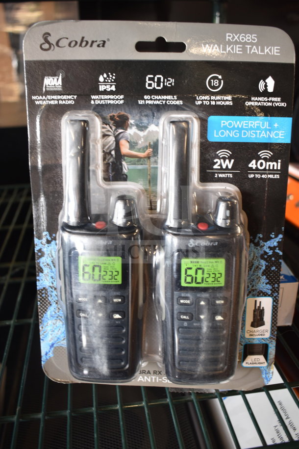 Cobra RX685 walkie talkies in packaging, featuring 60 channels, 40-mile range, and IP54 waterproof rating. Includes charger and flashlight.