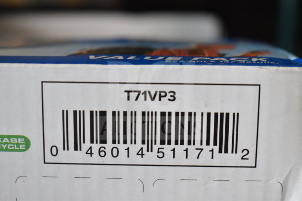 Close-up of a barcode on box labeled "T71VP3," part of an auction lot including a keyboard, Lego Smart Play, and walkie talkies.