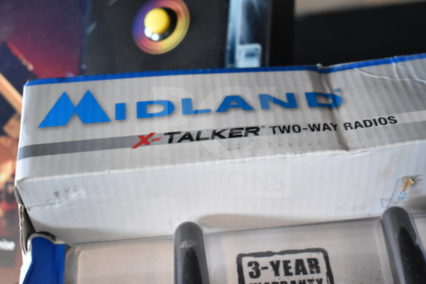 Midland X-Talker two-way radios box. Features a 3-year warranty label. Box shows some wear.