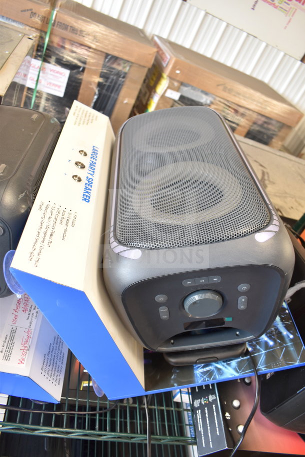 Onn Large Party Speaker display with control panel. Includes volume dial, play/pause buttons, and connectivity options.