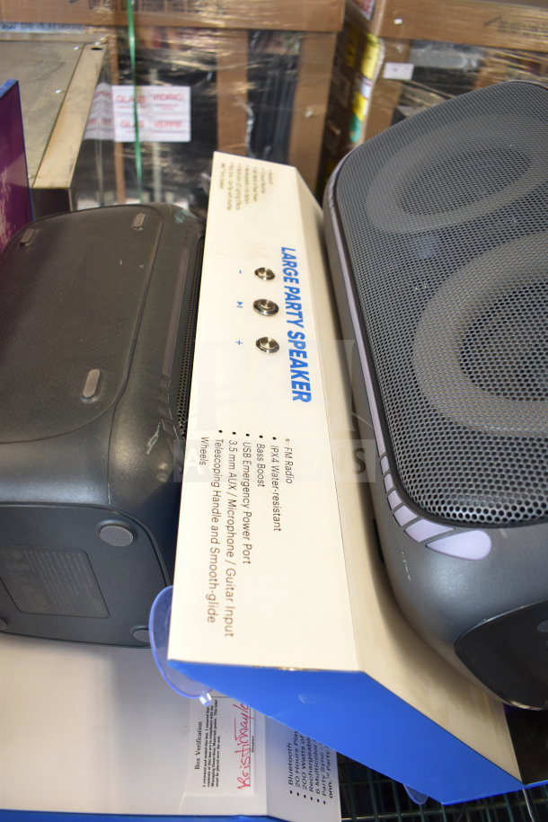 Onn Large Party Speaker in display with features listed: FM radio, water-resistant, bass boost, USB power port, mic input.