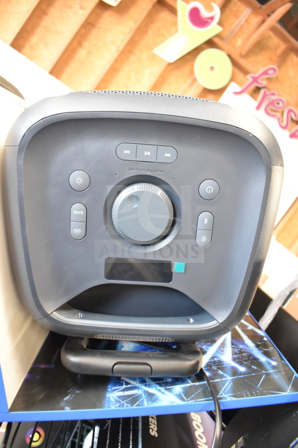 Onn large party speaker with control panel, bass and volume knobs, in a store display, new condition.