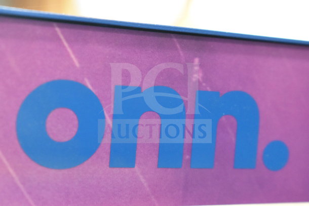 Close-up of Onn logo on a purple store display background.