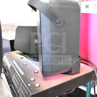 Store display featuring an Altec Lansing speaker on a metal shelf. The speaker is black with a textured handle.