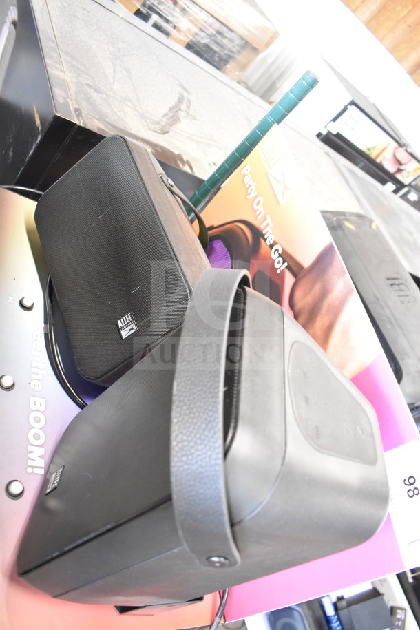 Store display featuring Altec Lansing speaker with marketing materials. Speaker in good condition, includes brand logo.