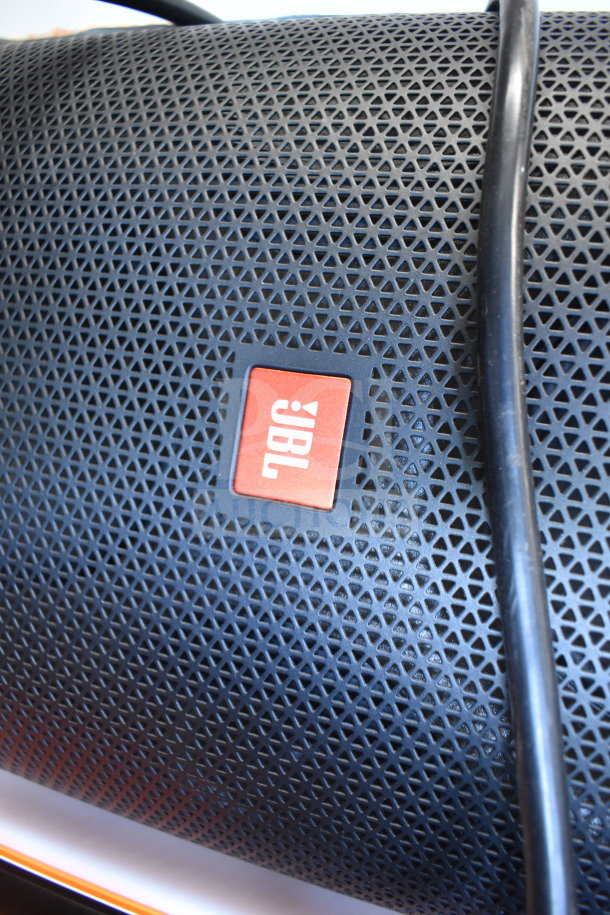 JBL speaker with black mesh grill, red logo, excellent condition, part of a 3-store display auction. Includes power cable.